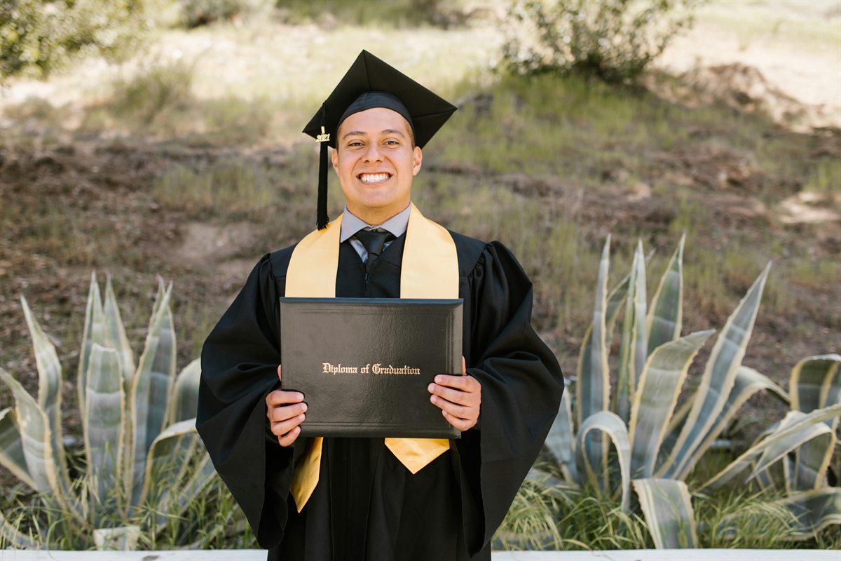 Graduate holding diploma representing long-term outcomes of 529 plan and Roth IRA college strategy