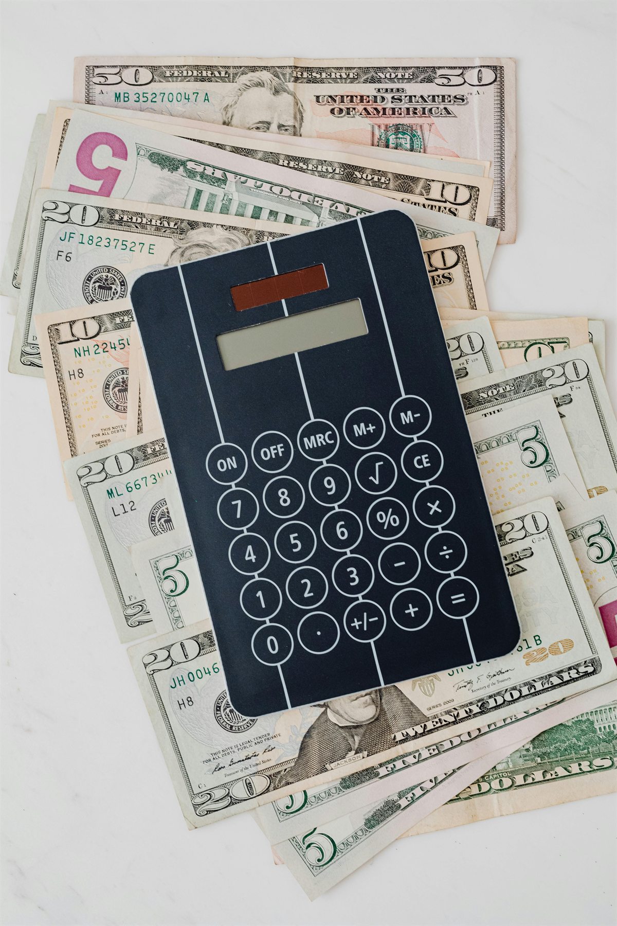 Calculator and cash illustrating 529 plan tax benefits versus Roth IRA withdrawal tradeoffs