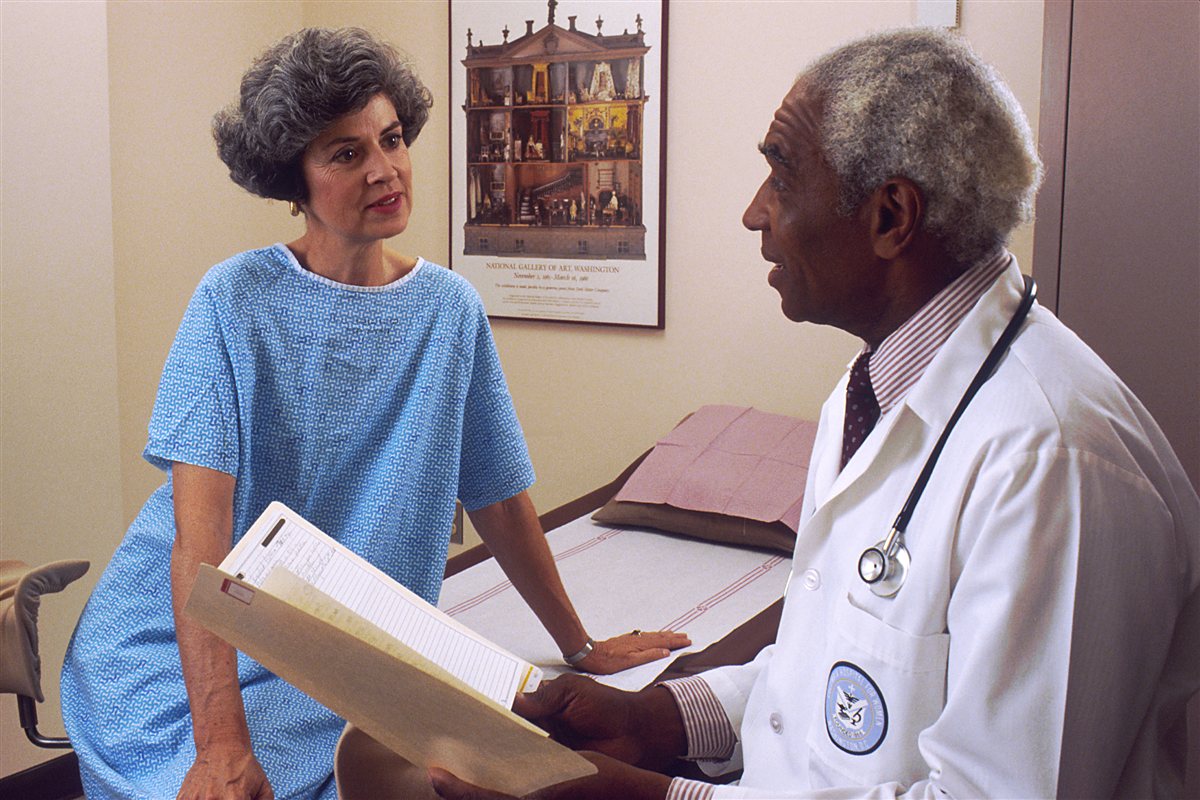 Doctor and patient reviewing family deductible and out of pocket maximum details
