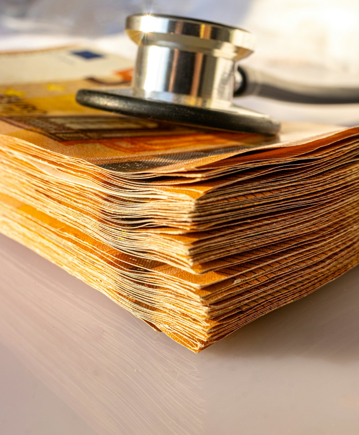Medical debt credit report paperwork with a stethoscope on unpaid bills